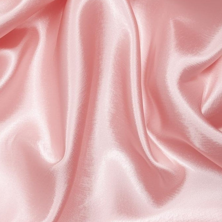 Close-up of pink silk fabric with soft folds